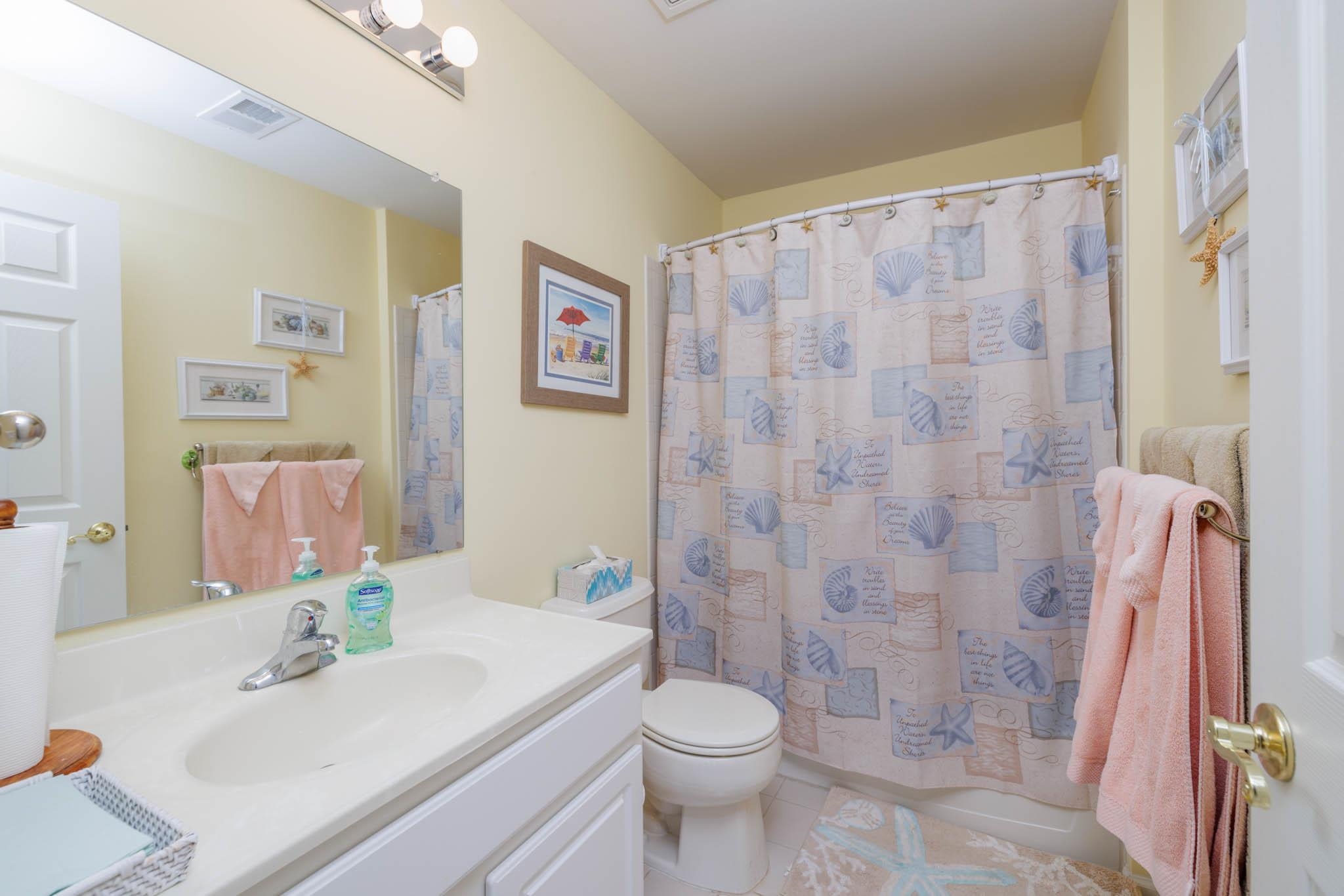118 Aberdeen Way Rio Grande, NJ 08242 - Photo 29 of 35 a bathroom with a sink a toilet and shower curtain