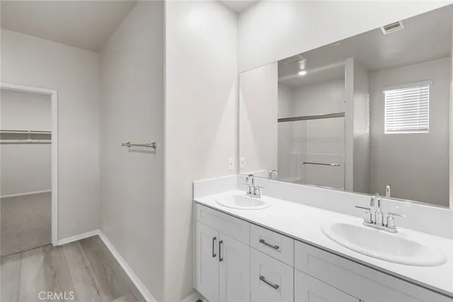 a bathroom with 2 sink and a mirror