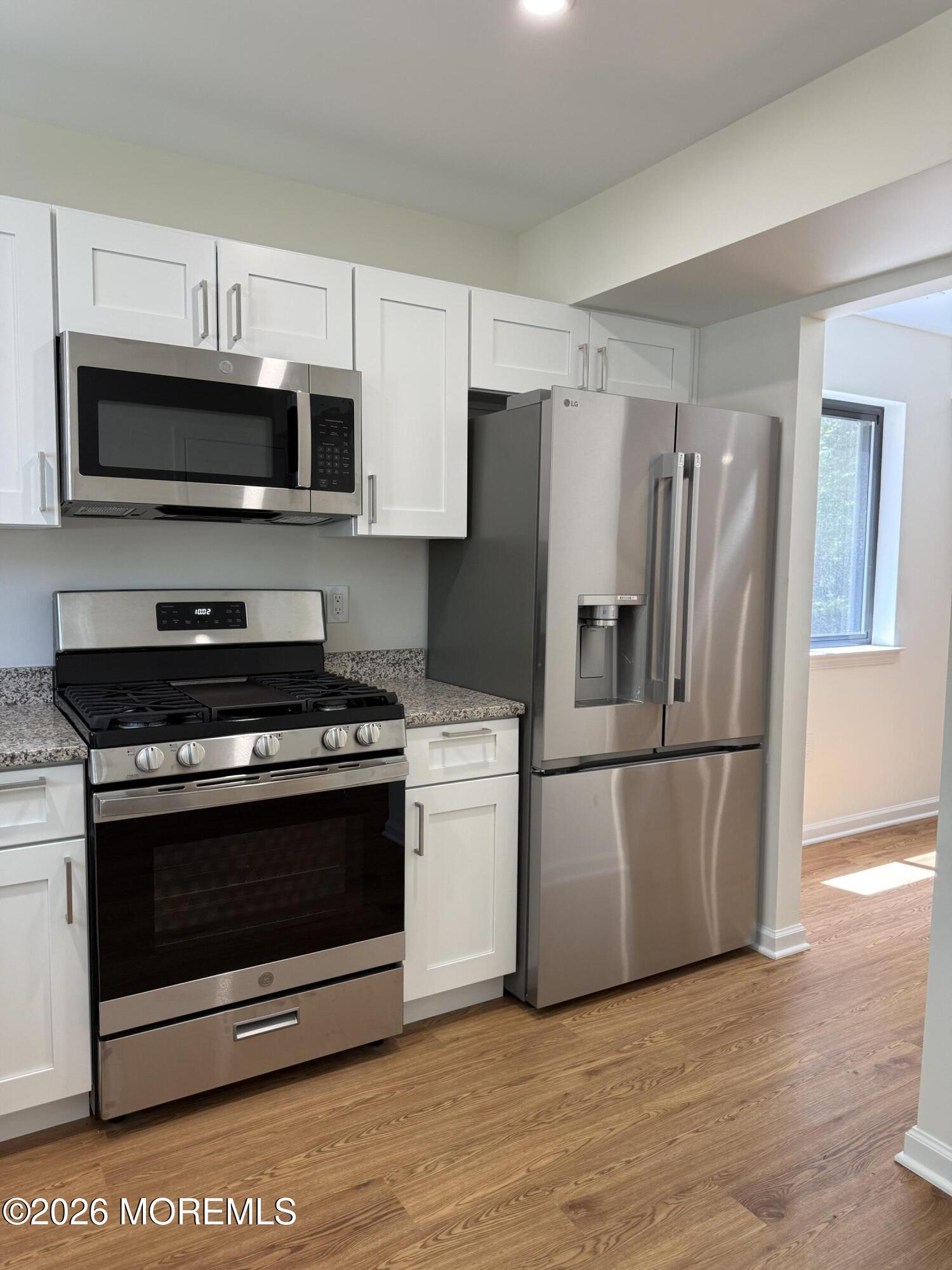 5 Canary Circle Howell, NJ 07731 - Photo 5 of 32 a kitchen with stainless steel appliances a refrigerator stove and microwave