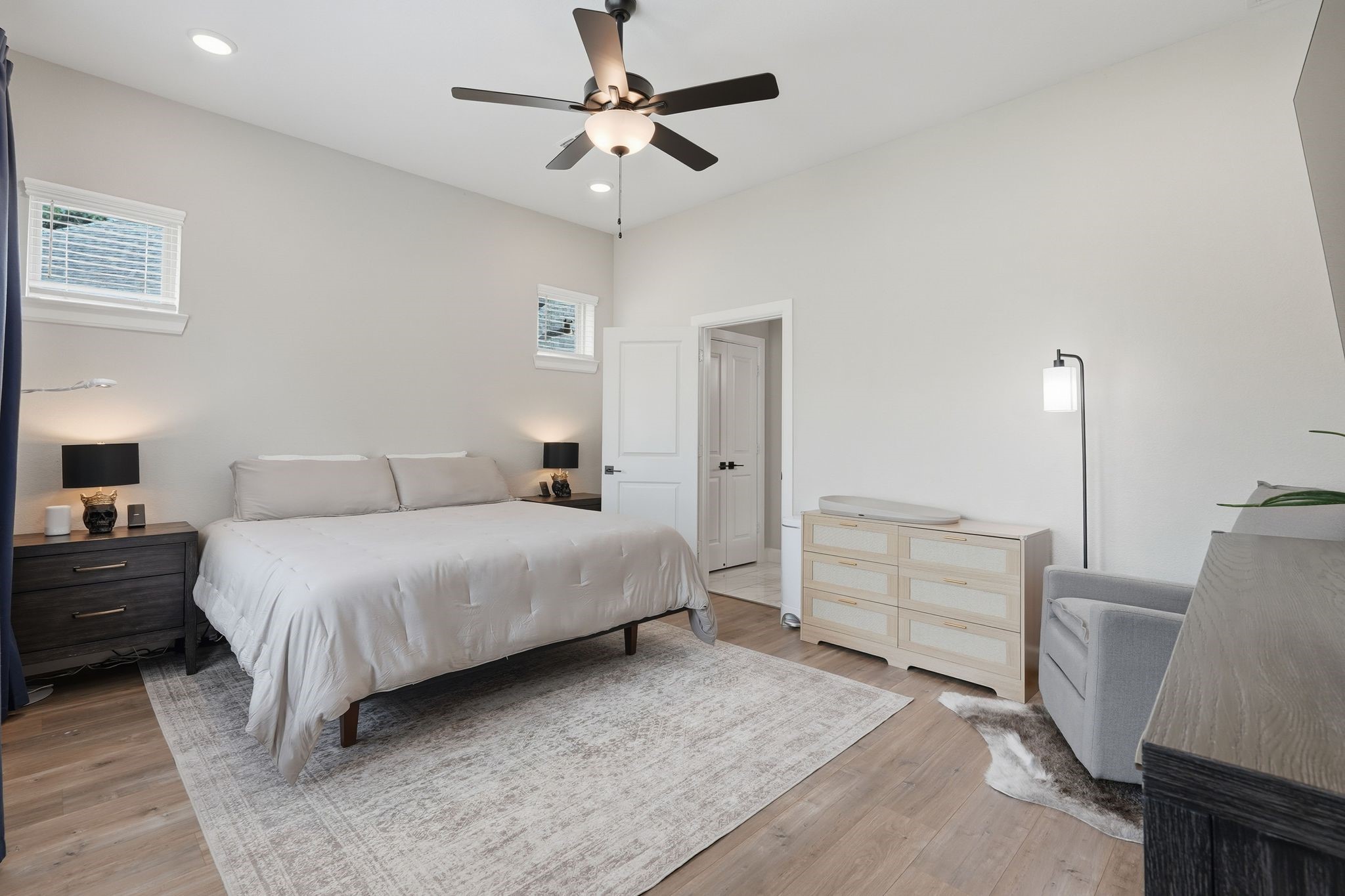 24423 Morningside Terrace Tomball, TX 77375 - Photo 41 of 47 a spacious bedroom with a bed a couch and a chandelier