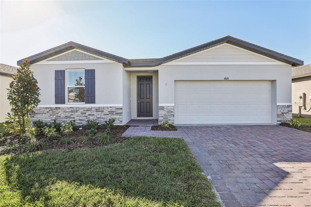 4018 Copperleaf Lane Kissimmee, FL 34759 - Photo 1 of 36 a front view of a house with a yard and garage