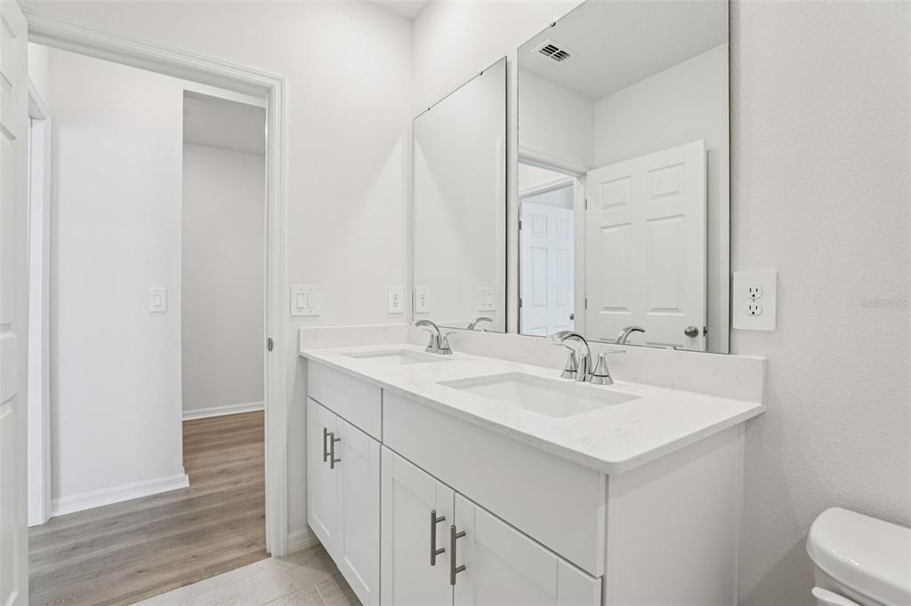 4018 Copperleaf Lane Kissimmee, FL 34759 - Photo 20 of 36 a bathroom with a sink and a mirror