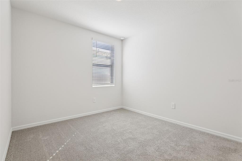 4018 Copperleaf Lane Kissimmee, FL 34759 - Photo 21 of 36 an empty room with windows