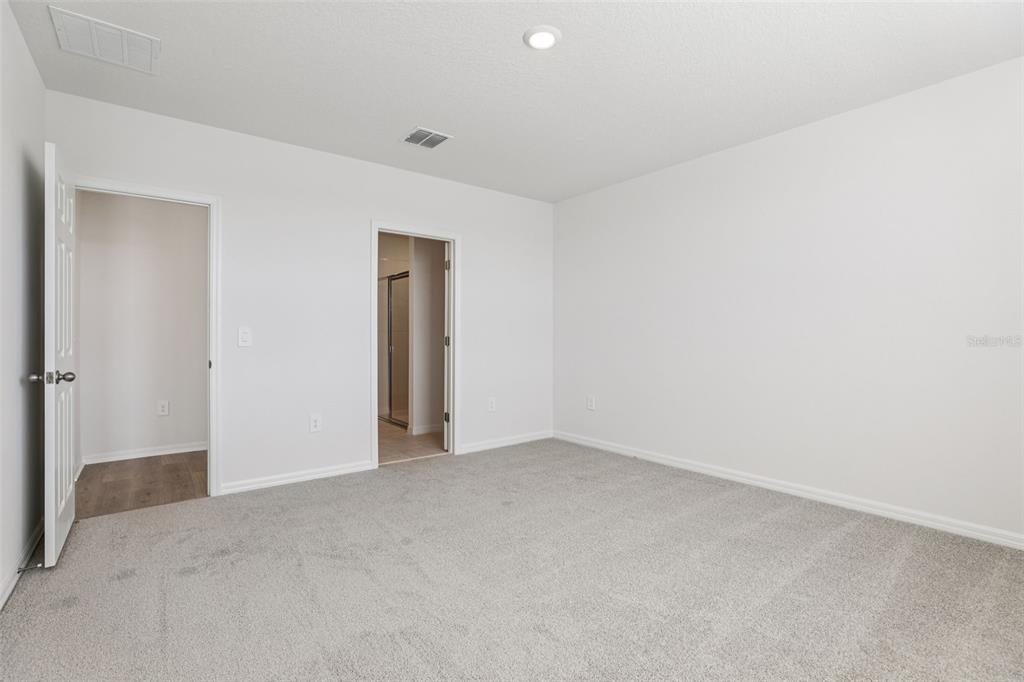 4018 Copperleaf Lane Kissimmee, FL 34759 - Photo 27 of 36 an empty room with an entryway