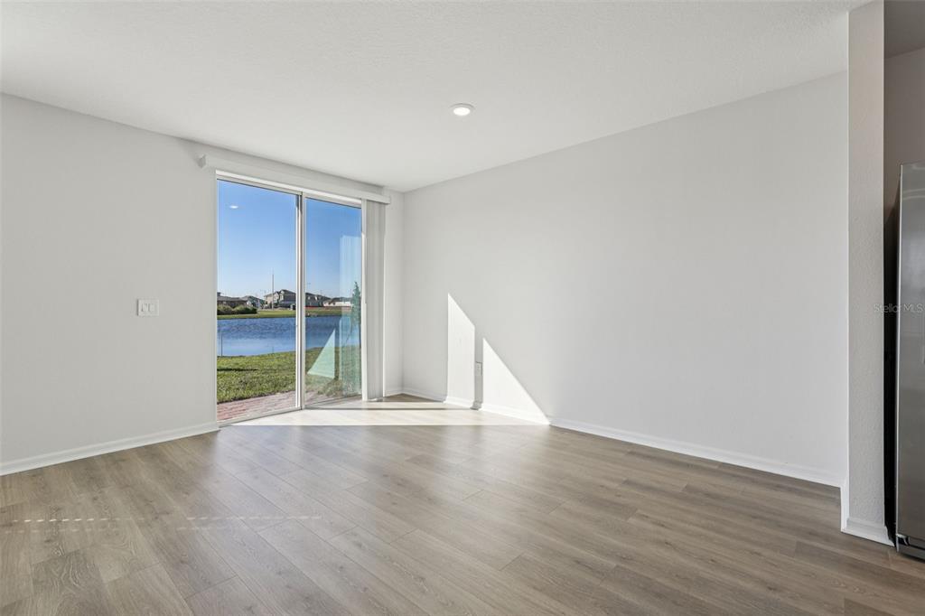 4018 Copperleaf Lane Kissimmee, FL 34759 - Photo 6 of 36 a view of an empty room with wooden floor