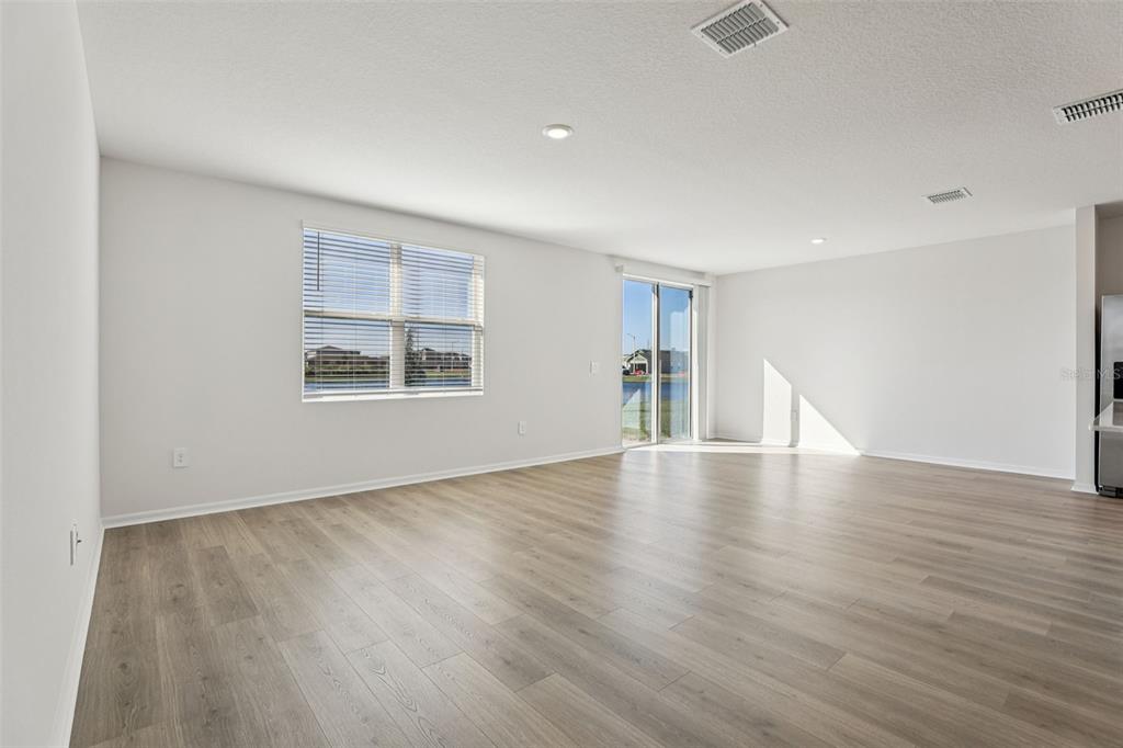 4018 Copperleaf Lane Kissimmee, FL 34759 - Photo 10 of 36 a view of empty room with wooden floor and fan