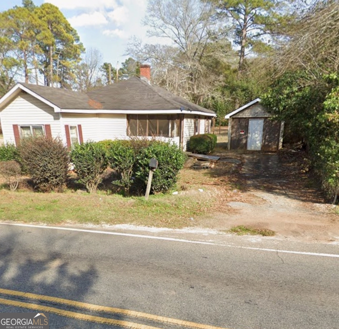 433 Mayo Street Americus, GA 31709 - Photo 3 of 9 a front view of a house with a yard and garage