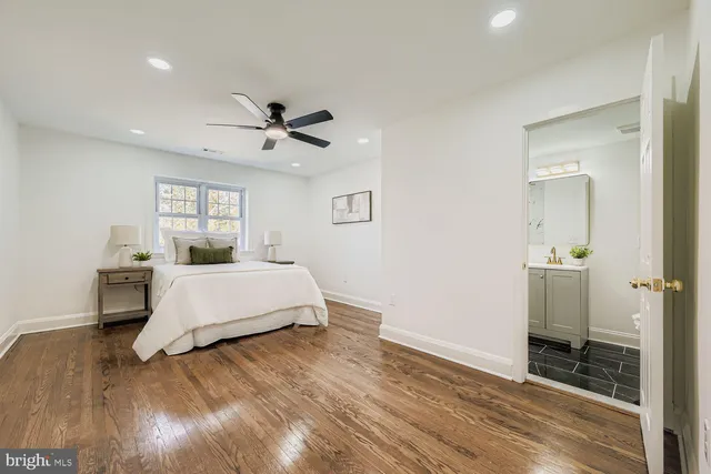 a spacious bedroom with a bed and a table in it