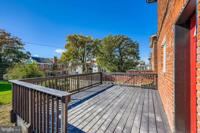 a view of balcony with wooden floor and fence