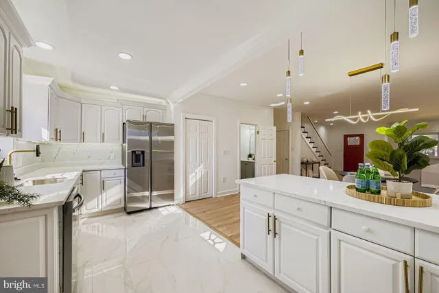 a large kitchen with cabinets and stainless steel appliances