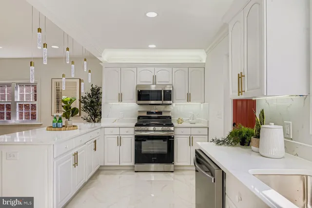 a kitchen with a stove top oven and sink