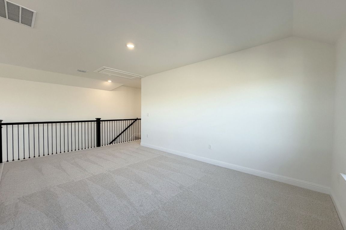 20301 Dustin Lane Pflugerville, TX 78660 - Photo 14 of 30 Unfurnished room featuring carpet flooring, recessed lighting, and vaulted ceiling