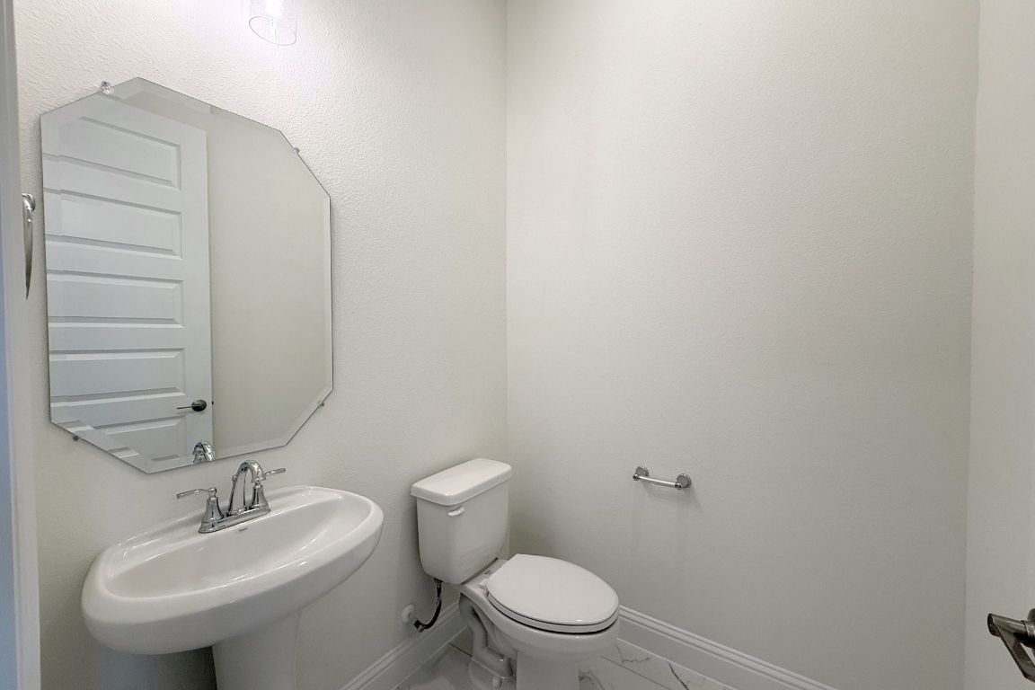 20301 Dustin Lane Pflugerville, TX 78660 - Photo 21 of 30 Bathroom featuring baseboards and marble finish floors