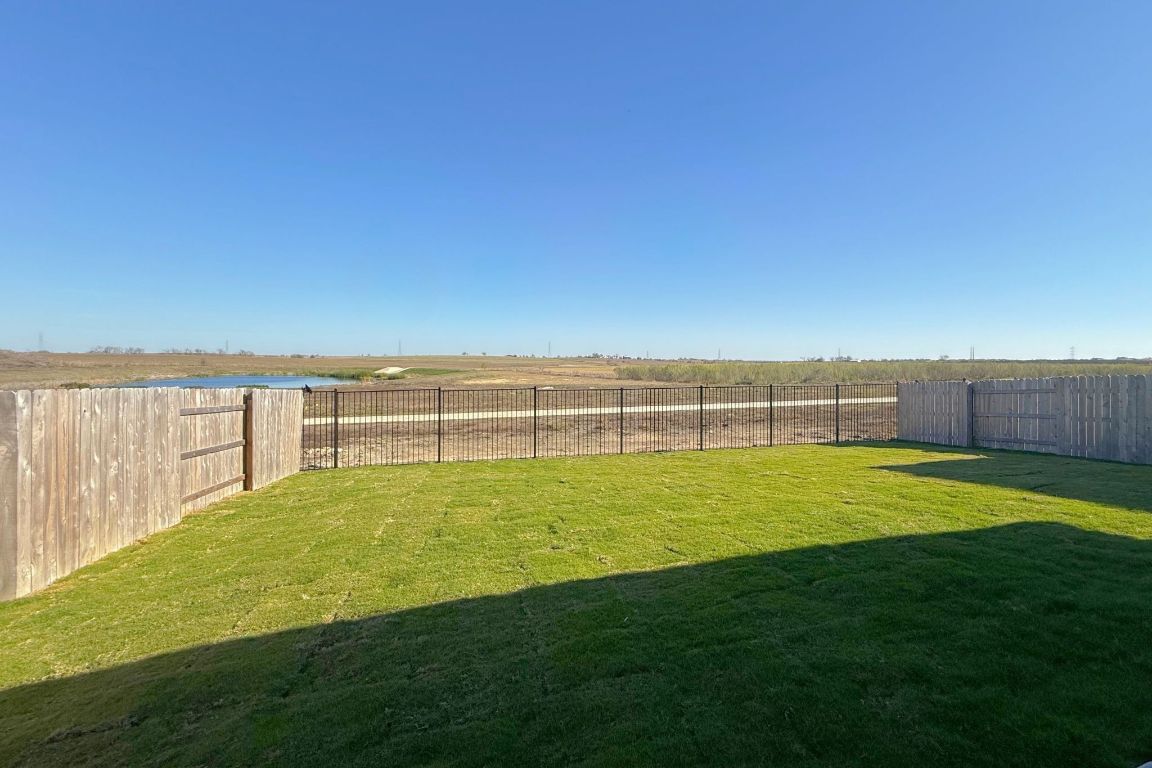 20301 Dustin Lane Pflugerville, TX 78660 - Photo 25 of 30 Fenced backyard with a view of countryside