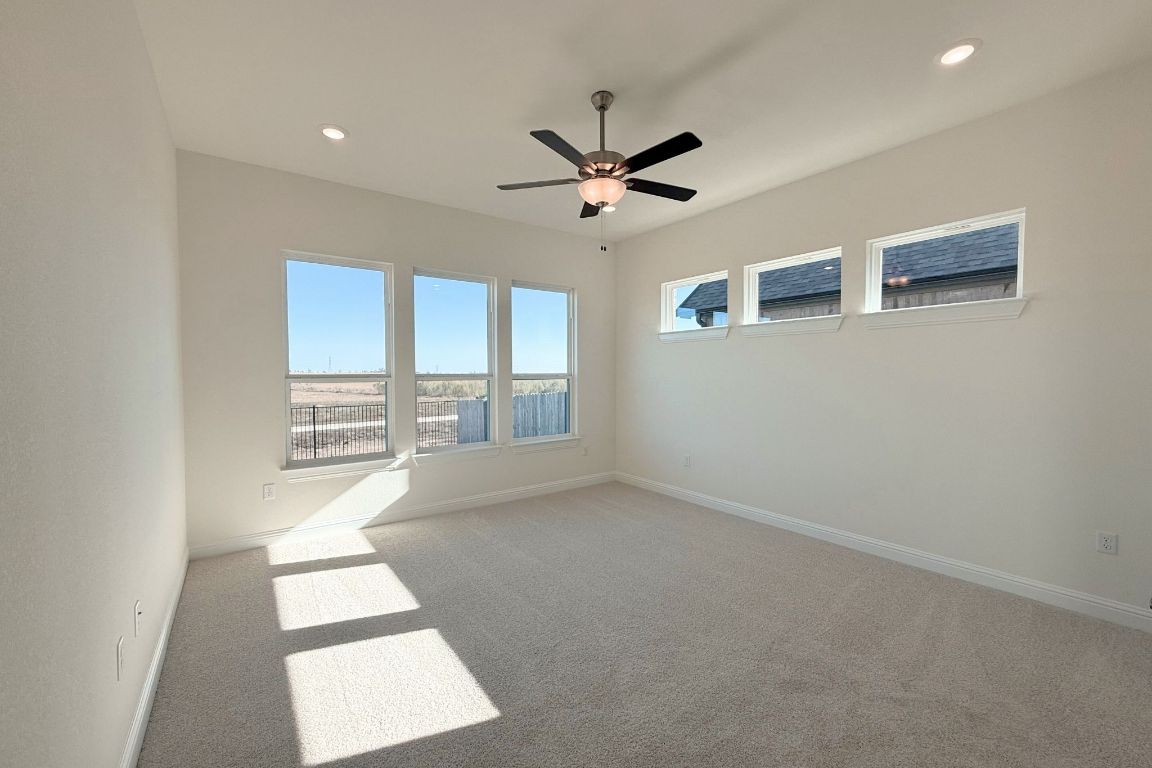 20301 Dustin Lane Pflugerville, TX 78660 - Photo 8 of 30 Spare room featuring light carpet, recessed lighting, and a ceiling fan