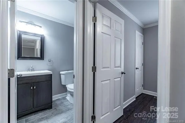 a bathroom with a toilet sink and mirror