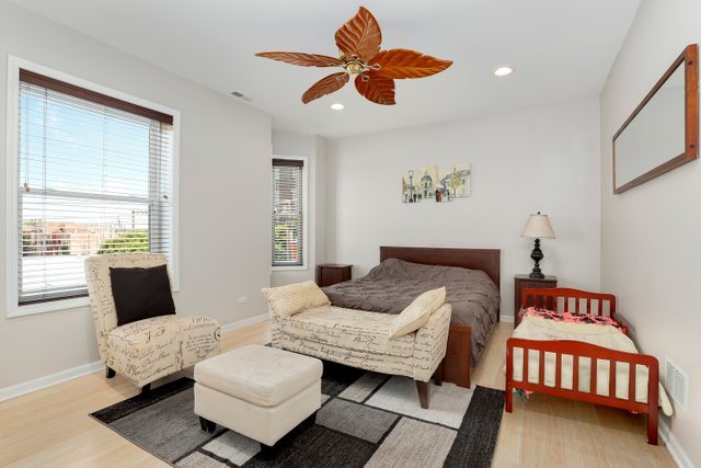 4714 South Evans Avenue, Unit 3N Chicago, IL 60615 - Photo 7 of 21 a bedroom with furniture and wooden floor