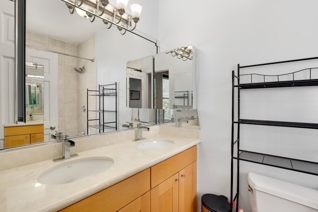 4714 South Evans Avenue, Unit 3N Chicago, IL 60615 - Photo 10 of 21 a bathroom with a sink double vanity and a mirror