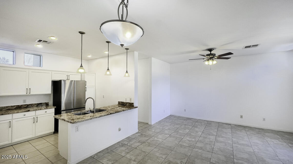 123 North Washington Street, Unit 22 Chandler, AZ 85225 - Photo 8 of 33 a kitchen with granite countertop a refrigerator and a stove