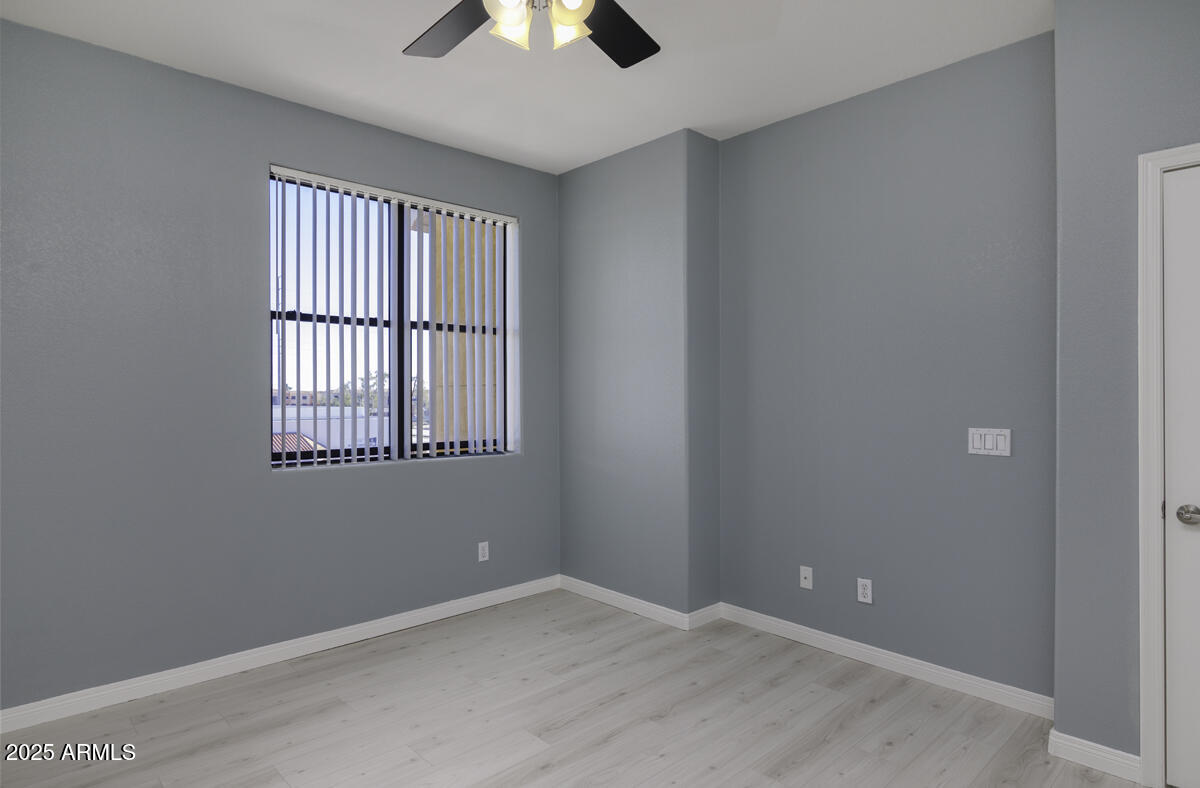 123 North Washington Street, Unit 22 Chandler, AZ 85225 - Photo 12 of 33 an empty room with chandelier fan and windows