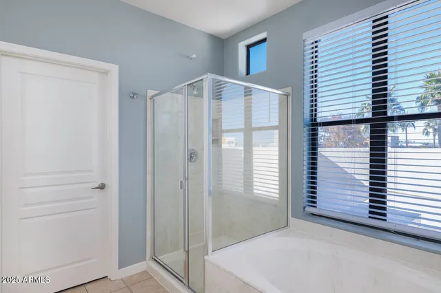 wooden floor in an empty room with a ceiling fan