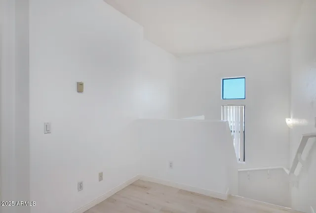 an empty room with windows and wall painting