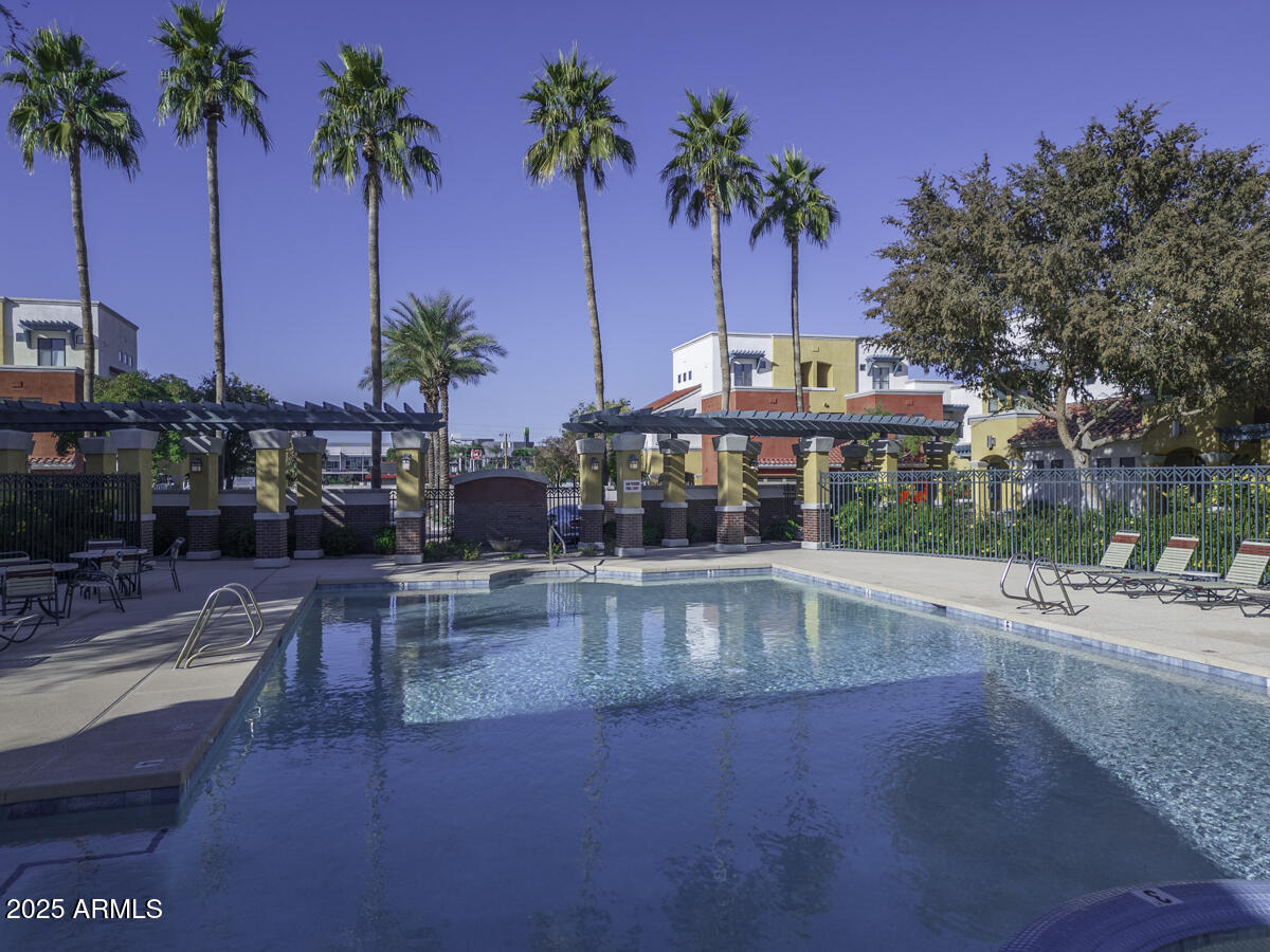 123 North Washington Street, Unit 22 Chandler, AZ 85225 - Photo 4 of 33 a swimming pool with outdoor seating and yard