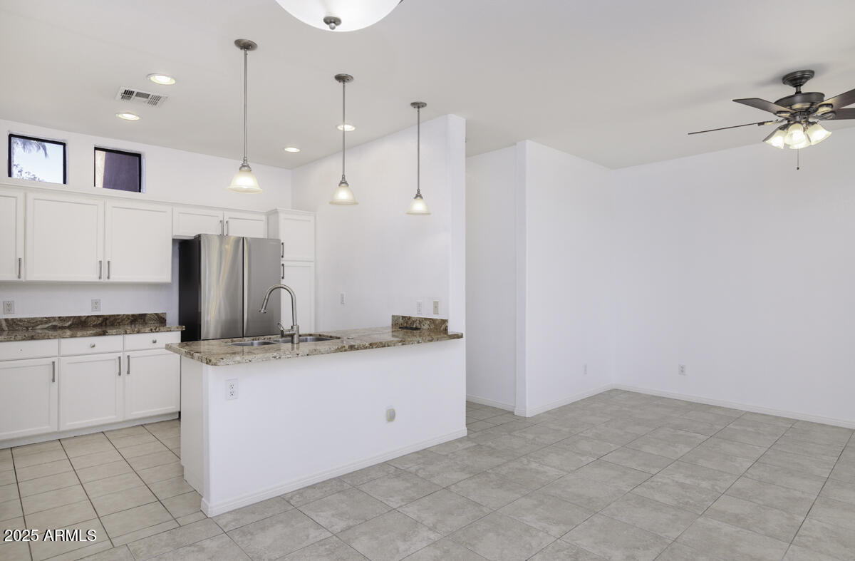 123 North Washington Street, Unit 22 Chandler, AZ 85225 - Photo 6 of 33 a kitchen with stainless steel appliances granite countertop a sink a stove and a refrigerator