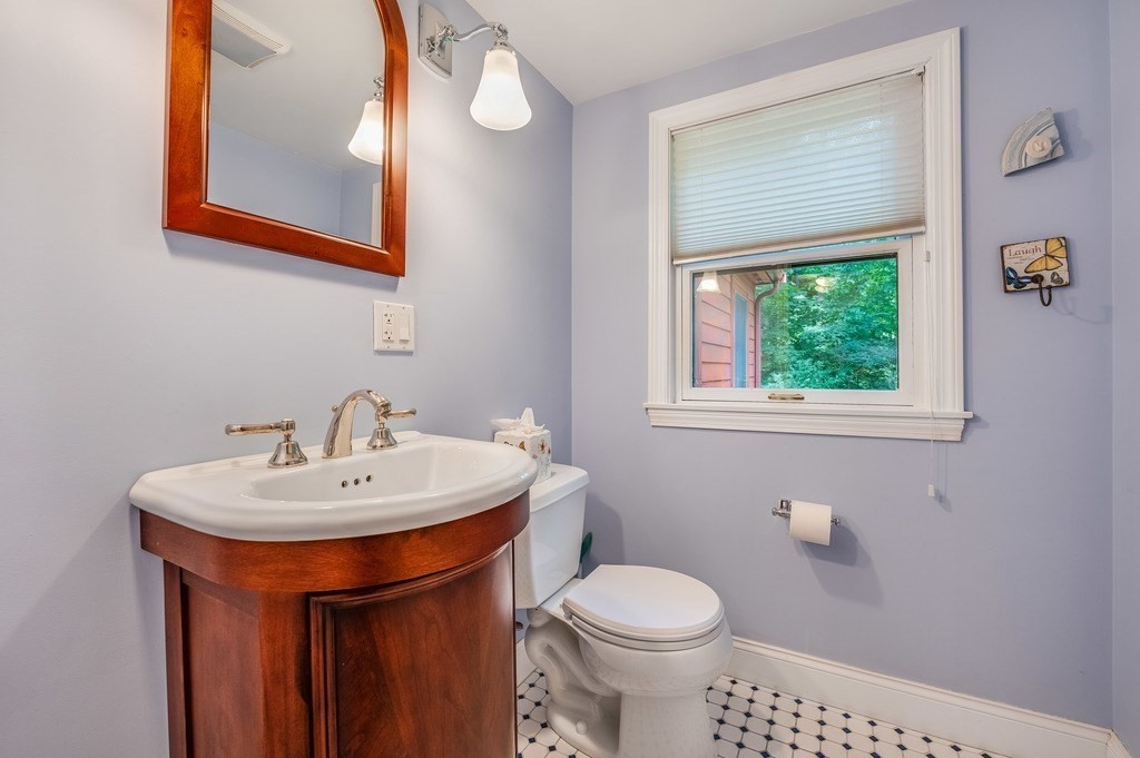 14 Mitchell Road Lynnfield, MA 01940 - Photo 21 of 36 a bathroom with a sink a toilet and a mirror