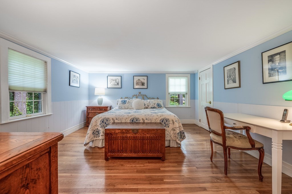 14 Mitchell Road Lynnfield, MA 01940 - Photo 22 of 36 a spacious bedroom with a bed and a table in it