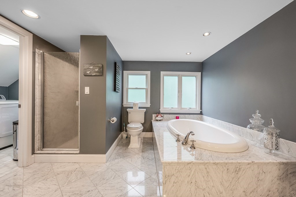 14 Mitchell Road Lynnfield, MA 01940 - Photo 30 of 36 a spacious bathroom with a granite countertop tub shower and mirror