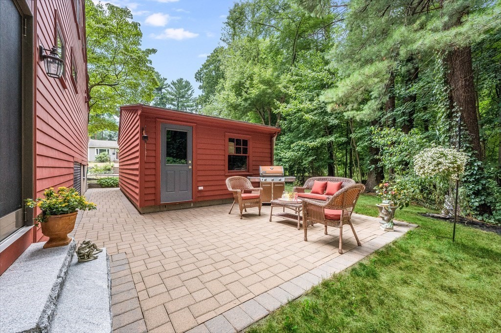 14 Mitchell Road Lynnfield, MA 01940 - Photo 32 of 36 a backyard of a house with table and chairs