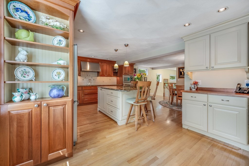14 Mitchell Road Lynnfield, MA 01940 - Photo 4 of 36 a kitchen with stainless steel appliances granite countertop a refrigerator oven a sink dishwasher and white cabinets with wooden floor