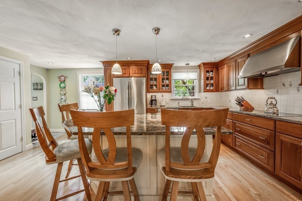 14 Mitchell Road Lynnfield, MA 01940 - Photo 7 of 36 a kitchen with stainless steel appliances granite countertop a dining table chairs and granite counter tops