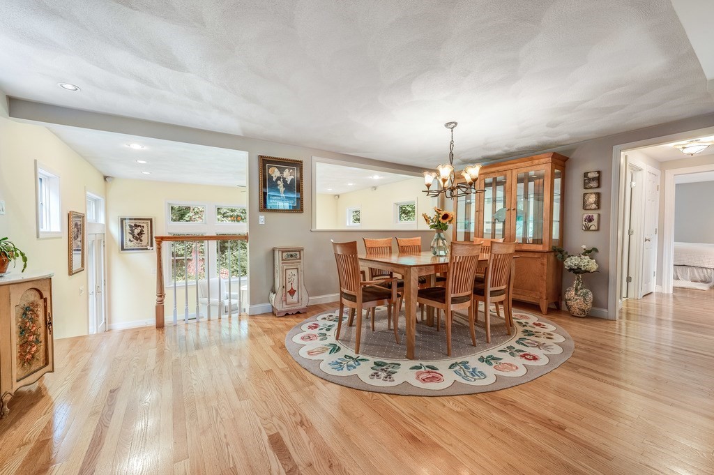 14 Mitchell Road Lynnfield, MA 01940 - Photo 10 of 36 a dining room with furniture a chandelier and wooden floor