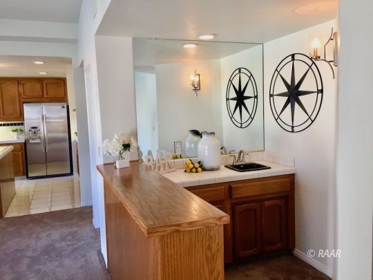 1108 Judy Way Ridgecrest, CA 93555 - Photo 14 of 35 a bathroom with a granite countertop sink a mirror and shower