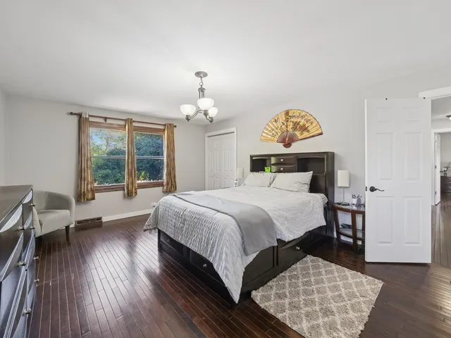 a bedroom with a large bed and a window