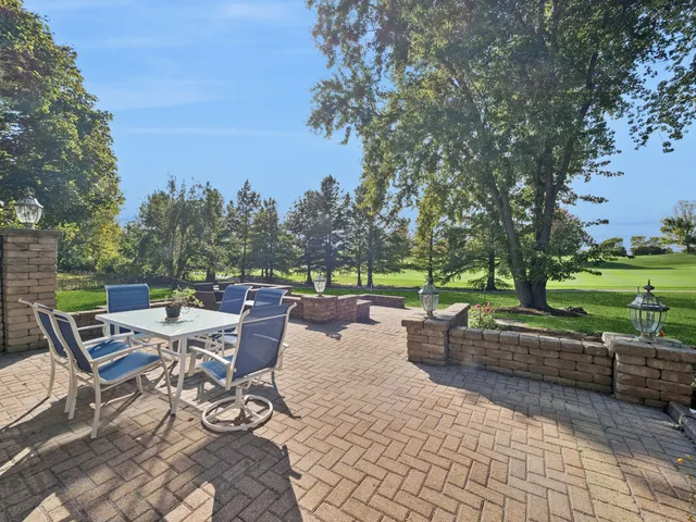 a view of a patio with couches and table and chairs and a barbeque