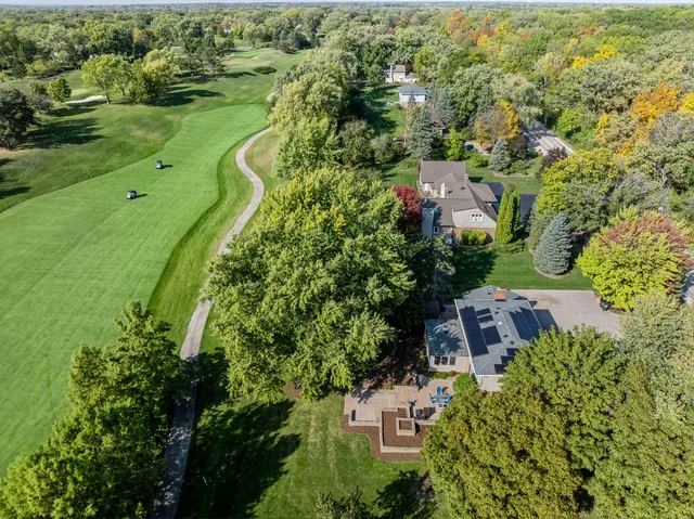 an aerial view of residential houses with outdoor space and street view
