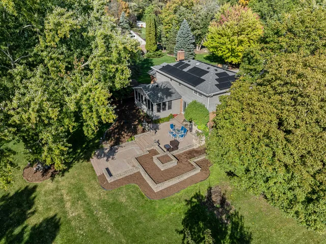 an aerial view of a house with a yard