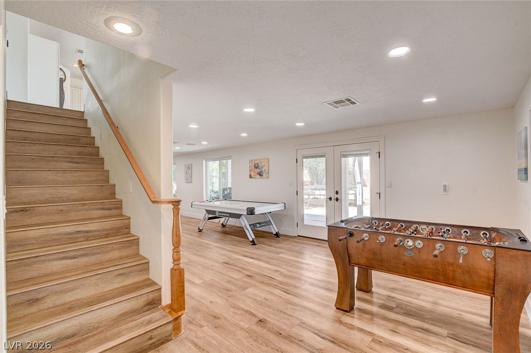 4362 Thistle Street Logandale, NV 89021 - Photo 40 of 99 A spacious recreation area with warm LVP flooring and French doors offers direct outdoor access.