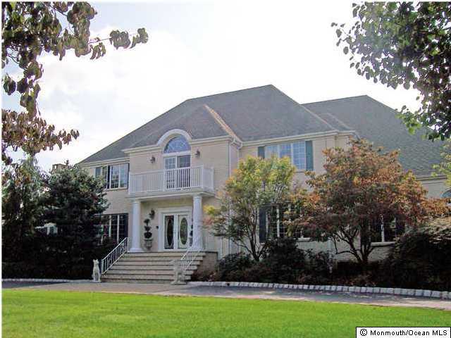 32 Mine Brook Road Colts Neck, NJ 07722 - Photo 1 of 3 a front view of a house with garden
