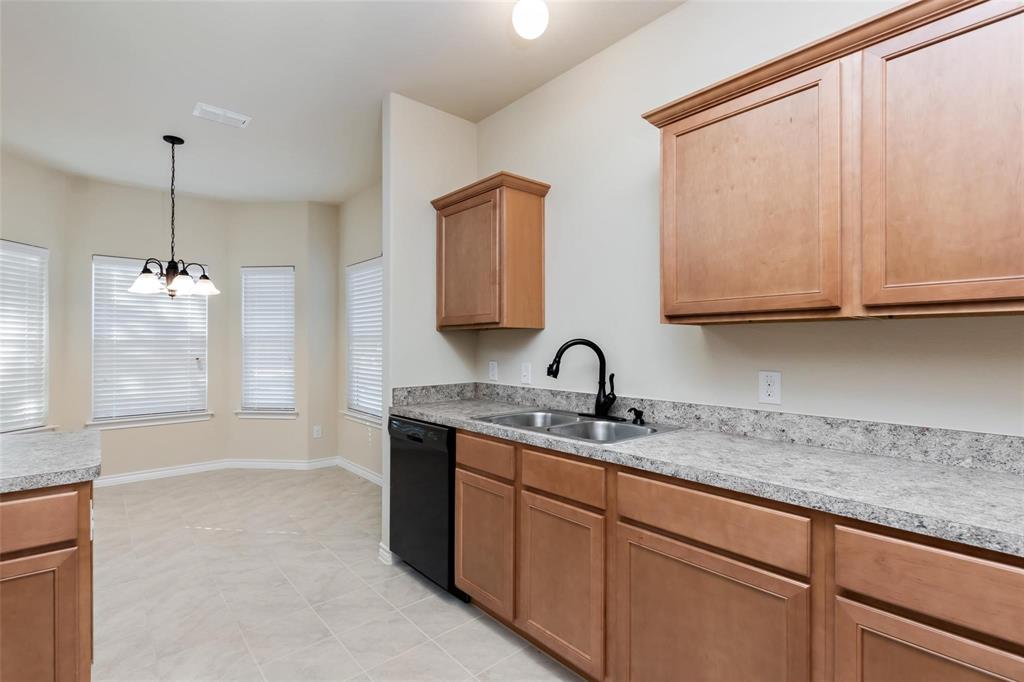 1119 East Epstein Street Sherman, TX 75090 - Photo 6 of 13 a bathroom with a granite countertop sink a mirror and shower