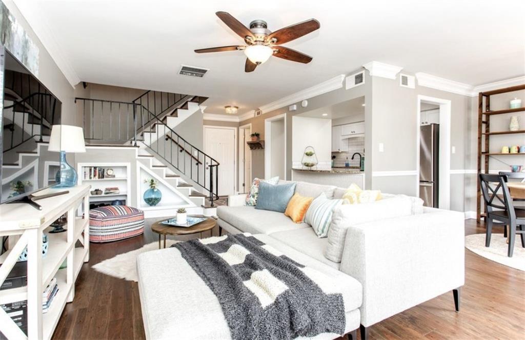 6980 Roswell Road, Unit B6 Atlanta, GA 30328 - Photo 3 of 31 a living room with furniture a fireplace and a flat screen tv