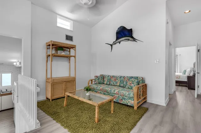 a living room with furniture and wooden floor