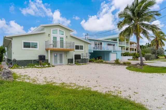 a living room with stainless steel appliances kitchen island granite countertop furniture and wooden floor