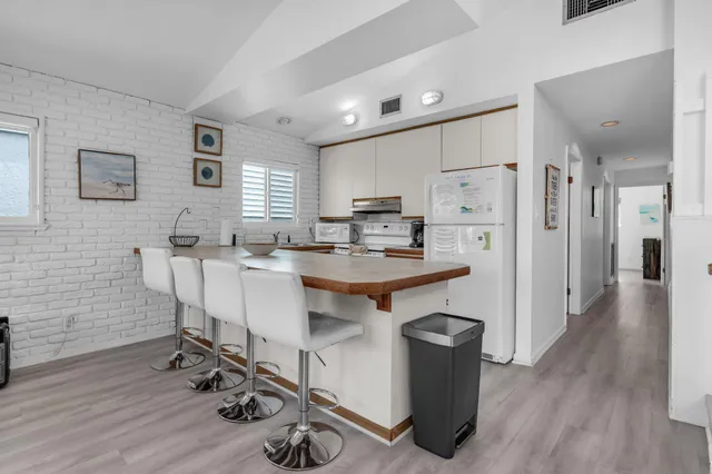 a kitchen with stainless steel appliances a stove a sink and a refrigerator
