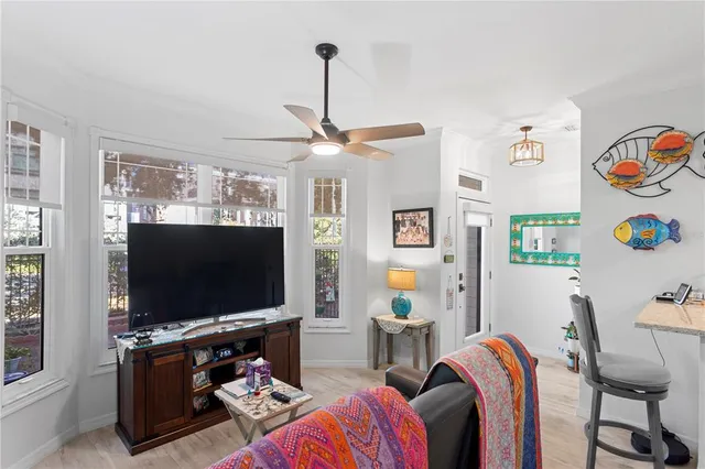 a kitchen with stainless steel appliances granite countertop a sink dishwasher a stove a dining table and chairs with wooden floor