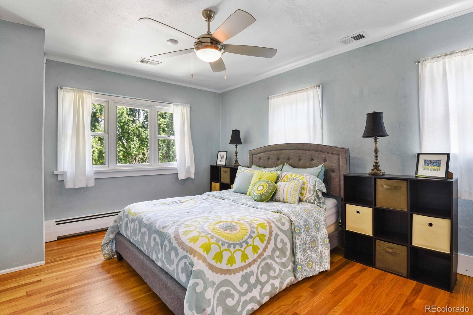 3615 Lowell Boulevard Denver, CO 80211 - Photo 11 of 23 a bedroom with a bed and wooden floor