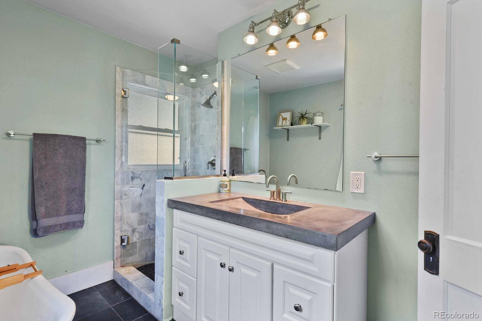 3615 Lowell Boulevard Denver, CO 80211 - Photo 13 of 23 a bathroom with a sink double vanity granite and a mirror